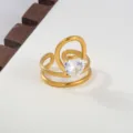 Close-up detail of a modern gold open ring featuring a sparkling heart-shaped cubic zirconia stone. - Heart Clear Zirconia Style / Gold
