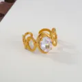 Detailed close-up of gold stainless steel open ring with sparkling oval cubic zirconia. - Hollow Geometric Link Style / Gold