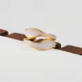 Exquisite gold stainless steel ring with elegant white wave design for modern stackable style. - Double-Layer Wavy White Glaze Style(224)