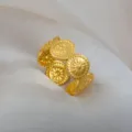 Adjustable stainless steel retro ring with floral embossed pattern in gold finish variant. - Round Floral Embossed Ring / Gold