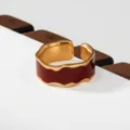 Stainless steel gold ring with deep red enamel inlay, elegant wavy design for women. - Dark Red Baked Enamel Wavy Style(324)