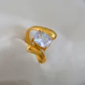 Gold-tone stainless steel open ring featuring a sparkling rectangular clear cubic zirconia. - Zircon Streamlined Asymmetric Ring / Gold