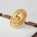 Gold stainless steel statement ring featuring a unique abstract spiral design, chic variant. - Abstract Swirl Style(580)
