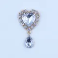 Gold alloy rhinestone heart charm pendant close-up, DIY jewelry making accessory detail view. - White