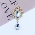 Detailed view of the golden alloy rhinestone pendant accessory, sparkling crystal teardrop design. - White