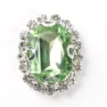 Close up of oval rectangular octagonal rhinestone claw chain button detail for DIY crafts. - Light Green