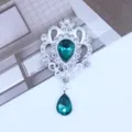 Close-up detail shot of silver alloy teardrop rhinestone pendant DIY decorative accessory. - Cyan