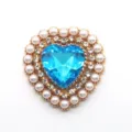 Close-up detail of heart-shaped DIY alloy rhinestone acrylic blue diamond and pearl button part. - Lake Blue