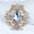Close-up detail of 28x32mm alloy rhinestone acrylic flower button DIY jewelry accessory. - White