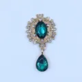 Vintage gold-tone alloy flower brooch with green gems and rhinestones for DIY clothing decor. - Cyan