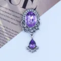 Close-up detail of vintage antique silver alloy rhinestone and acrylic pendant jewelry piece. - Light Purple