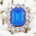 Close-up detail of rectangular blue rhinestone alloy crystal button decoration accessory. - Sapphire Blue