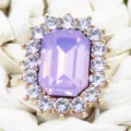 Close-up detail of rectangular purple crystal rhinestone button with gold alloy base and clear stones. - Light Purple