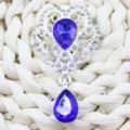 Silver alloy floral pendant brooch with purple teardrop crystal and clear rhinestones. - Sapphire Blue