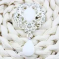 Vintage silver alloy floral brooch with white teardrop pendant and crystal rhinestones accessory. - Stone White