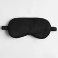 Black silk sleep mask with floral jacquard pattern, soft elastic band for comfortable rest. - Black