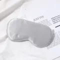 Zilveren zijden slaapmasker voor comfortabele nachtrust, zacht en ademend materiaal. - Zilverijs