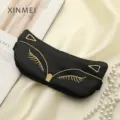 Black silk sleep mask with gold cat embroidery, soft and comfortable for night resting. - Black