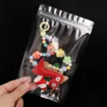 Kleurrijke kralen telefoonbedel riem met schattige cartoon dinosaurus hanger voor dames. - 12x20cm 16 Mil 20 Stuks