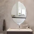 Detailed view of the decorative scalloped wall mirror showcasing its unique elegant curved edge. - JM706