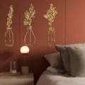 Detail view of 3D gold acrylic mirror wall stickers featuring floral and vase designs in bedroom. - 2mm Thick - S / Gold