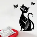 Detailed view of black acrylic cat wall clock with butterfly decor on white wall. - GZ003 Cat Style / Black