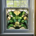 Detailed view of stained glass window film featuring elegant art deco fan pattern in green. - BL311