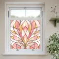 Detailed view of pink and gold stained glass window film, creating a warm and elegant atmosphere. - BL323