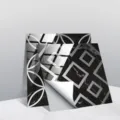 Detail view of black marble geometric tile stickers showing peeling backing paper and crystal film. - TS241