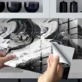 Close-up detail of black and white marble tile sticker showing peelable backing and glossy. - 4 Pieces Pack / DLS054