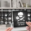 Close-up detail of self-adhesive chalkboard kitchen tile sticker with chef hat and stylish text. - ET233 / Glossy Film 10x10cm - 24 Pieces