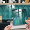 Peel and stick tile sticker with teal peacock feather pattern, glossy crystal film finish. - 10x10 cm - 25 Pieces / DJ054