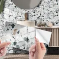 Close-up view of self-adhesive terrazzo tile sticker peel and stick application process. - DLS119
