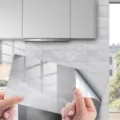 Marble pattern tile sticker detail view showing self-adhesive backing and peel-off layer. - DLS101 Crystal Film