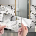 Terrazzo wall sticker self adhesive vinyl tile film detail showing backing paper peeling. - DLS131