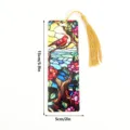 Detailed view of stained glass style bookmark with red bird pattern and gold tassel. - SQTYU026