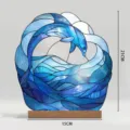 Close up detail view of stained glass dolphin wave acrylic ornament with wooden base support. - BTU493