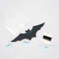 Nahaufnahme von 3D-Perlglanzpapier-Fledermaus-Dekorationen mit Klebepunkten und Aufhängeband. - Fledermaus