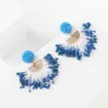 Detailed close-up shot of blue and white beaded tassel earrings with gold metal elements. - Blue And White (No.1)