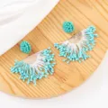 Handmade turquoise beaded tassel earrings featuring gold tone half-circle details. - Turquoise And White (No.2)