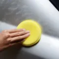 Yellow round car waxing sponge with edging design, ideal for auto detailing and paint care. - Single Piece