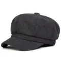 Detailed view of the dark grey herringbone tweed newsboy cap, showing fine texture and brim. - One Size / Black and Gray
