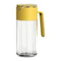 Clear glass oil dispenser bottle with yellow lid and automatic opening spout for kitchen use. - 550ml / Yellow