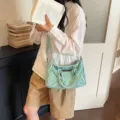Retro washed denim motorcycle bag for women, stylish shoulder crossbody tote bag with vintage vibe. - Green