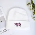 White knitted beanie for autumn and winter, featuring a cute pink cartoon animal embroidery. - White