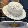 Detailed view of women's hollow woven straw hat, elegant beige summer beach sun hat. - White Hollow Straw Hat with Belt