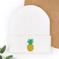 White knitted beanie hat featuring a cute embroidered pineapple design for women and men. - Cooling Cap with Pineapple Embroidery - White