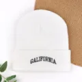 White knitted beanie winter hat with black embroidered letter design, warm pullover style. - Embroidered "GAL" Winter Beanie - White