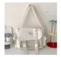 Canvas messenger bag detail showing transparent front mesh pocket and double buckle straps. - White