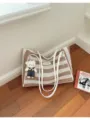 Vue détaillée du sac cabas en tricot rayé avec charm's ours, élégant sac d'épaule plage. - Style Tote / Khaki Avec Pendentif